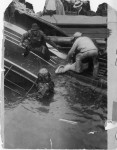 Diver and other rescue workers recover victim of Eastland disaster. Photo by Jun Fujita.